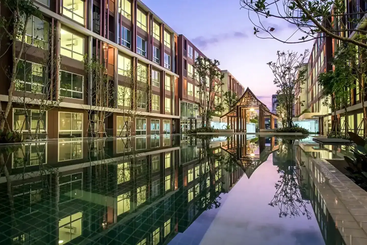 D'Vieng Santitham residence buildings and garden waterway at dusk in Chiang Mai