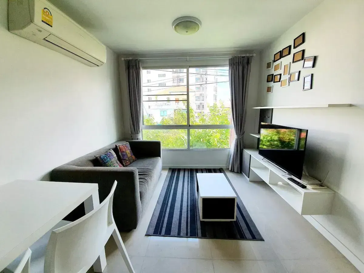 Bright living room with sofa and panoramic city view